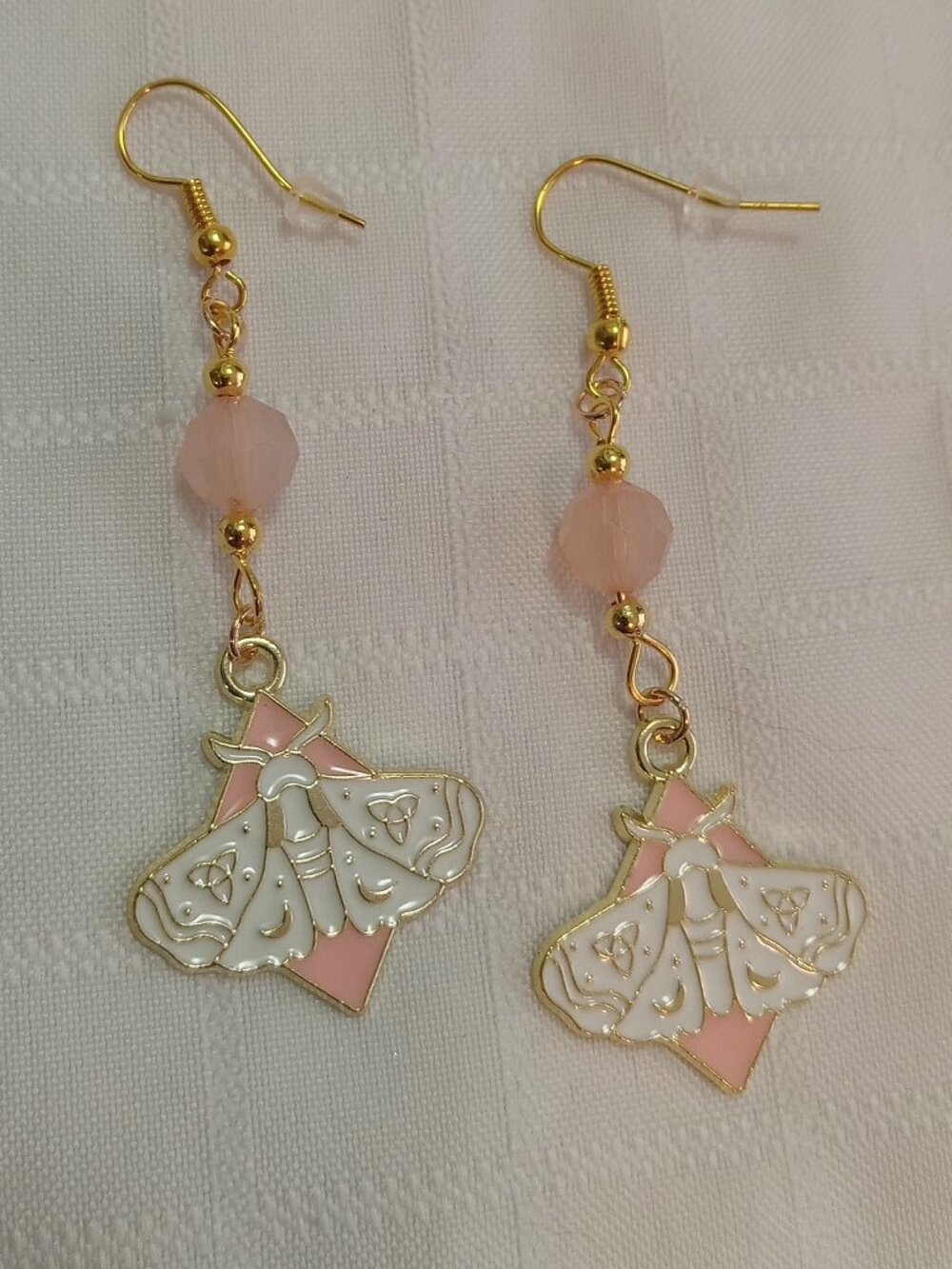 Handmade gold-colored earrings with multicolored enameled butterflies and beads